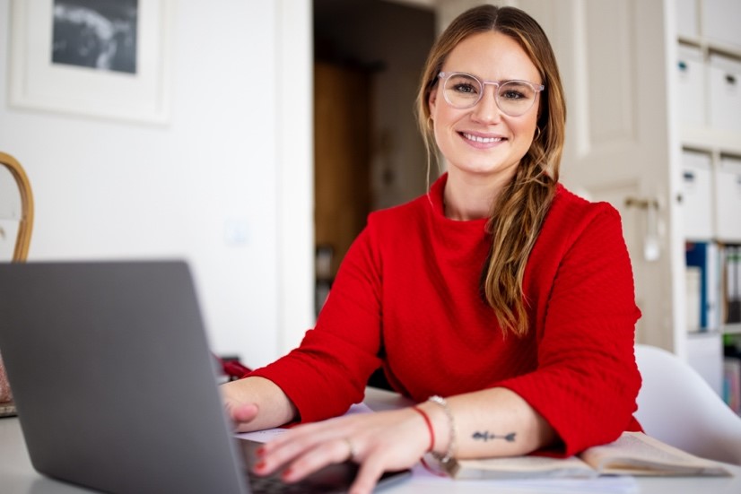 Photo of young woman using a laptop