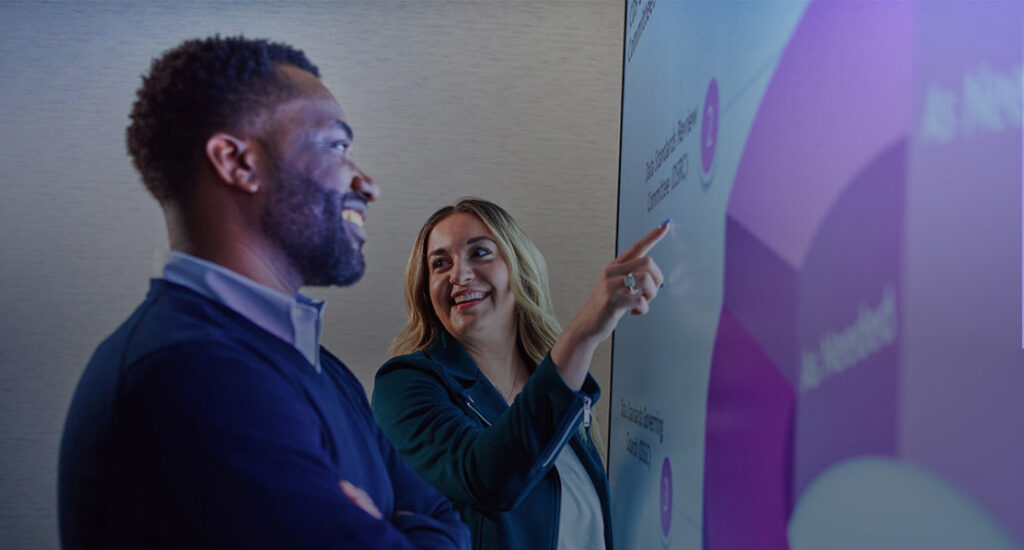 Photo of man and woman giving presentation