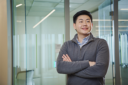 Photo of young employee with arms crossed