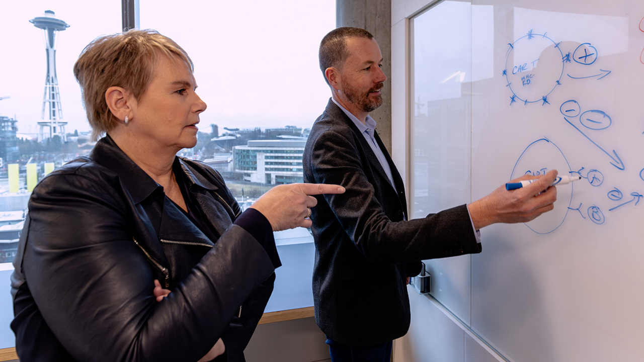 Video thumbnail showing two people collaborating with a whiteboard