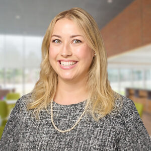 Maggie Cosgrove, BMS employee with blonde hair, dark top and a smile.